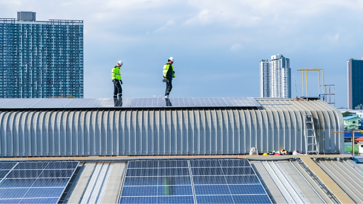 Workers installing solar panels on a rooftop
